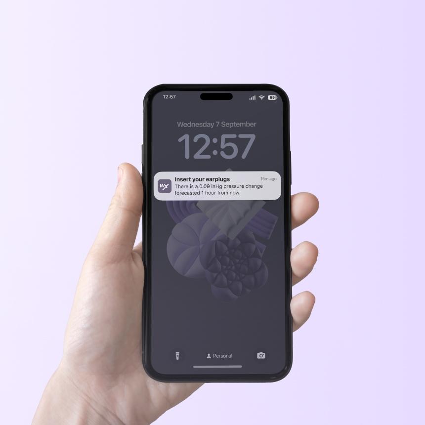 WeatherX app lock screen showing a pressure-change alert notification